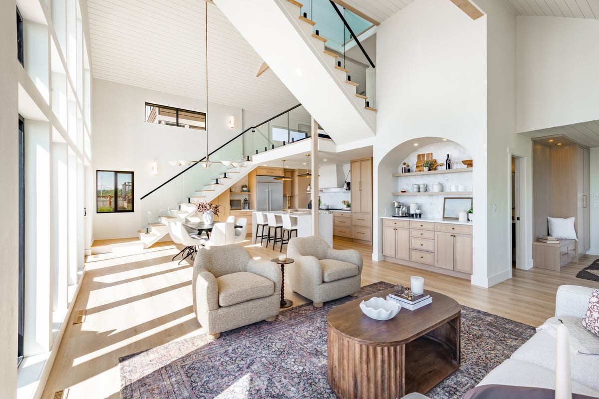 Bright, airy modern home interior with large windows and neutral warm tones